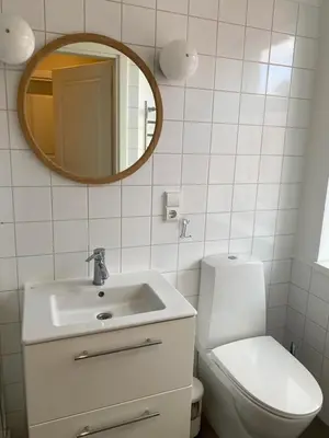 a bathroom with a sink and a toilet and a mirror at 