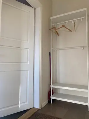 a white closet with a white door at 
