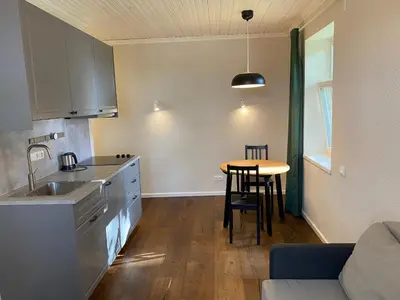 a kitchen with a sink and a table in a room at 