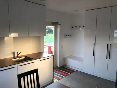 a kitchen with white cabinets and a sink at Villa Ievyne 2 in Paežeriai