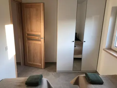 a bedroom with a mirror next to a door at Villa Ievyne 2 in Paežeriai