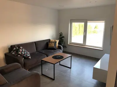 a living room with a couch and a coffee table at Villa Ievyne 2 in Paežeriai