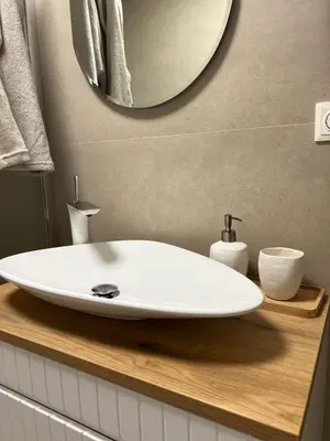 a bathroom with a white sink and a mirror at Walnut House in Kulautuva