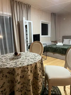 a room with a table and chairs and a bed at Walnut House in Kulautuva