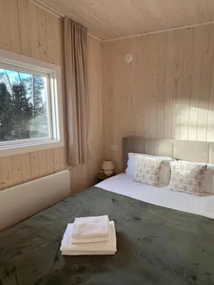 a bedroom with a large bed with a window at Walnut House in Kulautuva