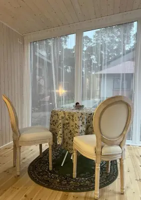 two chairs and a table in a room with a window at Walnut House in Kulautuva