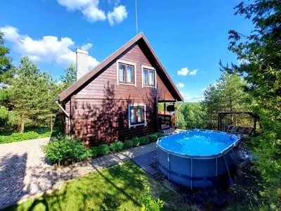 a house with a hot tub in the yard at Sodyba Vilagio in Alanta