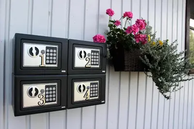 two black and white clocks on a wall with a basket of flowers at Vila Romnesa in Ignalina