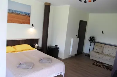 a bedroom with a bed with two towels on it at Vila Romnesa in Ignalina