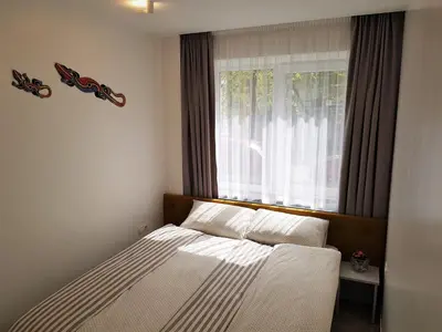 a small bedroom with a bed with a window at Apartment For You in Šiauliai