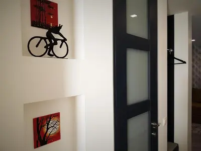 a cat on a bike hanging on a wall at Apartment For You in Šiauliai