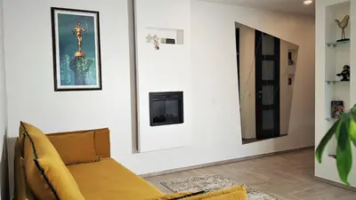 a living room with a couch and some pictures on the wall at Apartment For You in Šiauliai