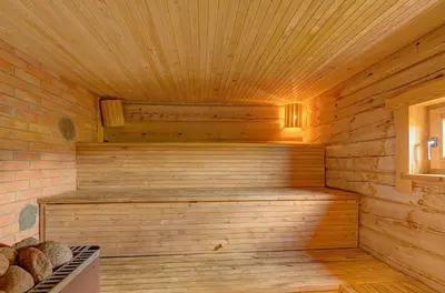 a sauna with wooden walls and a wooden ceiling at Sauna with the Private Lake Access in Molėtai