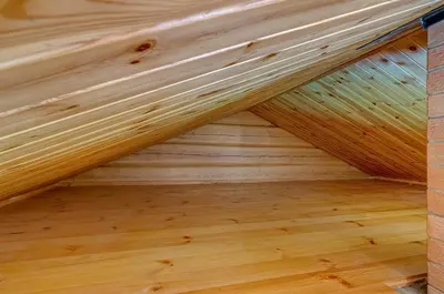 an attic with wood paneling and a wooden floor at Sauna with the Private Lake Access in Molėtai