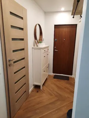 a room with a door and a dresser and a mirror at DanGinta in Druskininkai