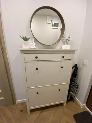 a dresser with a mirror on top of it at DanGinta in Druskininkai