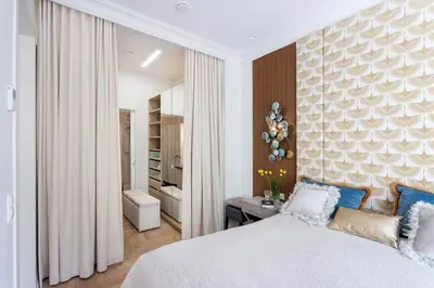 a bedroom with a large bed and a bathroom at Jogailos Residence peaceful Old Town luxury 3 bdr, 2 bthr, FREE GARAGE, top-speed WIFI in Vilnius