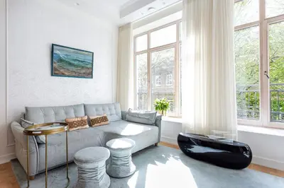 a living room with a couch and a table at Jogailos Residence peaceful Old Town luxury 3 bdr, 2 bthr, FREE GARAGE, top-speed WIFI in Vilnius