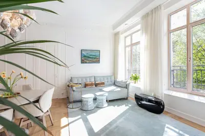a living room with a couch and a table at Jogailos Residence peaceful Old Town luxury 3 bdr, 2 bthr, FREE GARAGE, top-speed WIFI in Vilnius