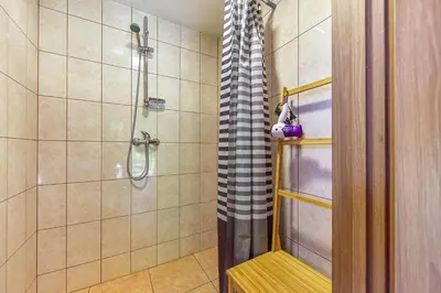 a bathroom with a shower with a glass door at Spacious Loft in the Nature in Molėtai