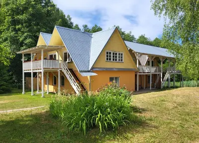 a house with a metal roof on top of it at Sodyba - Antalieptės marios in Zarasai