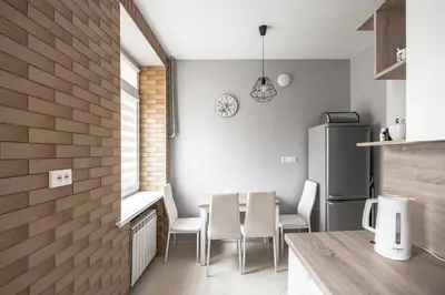 a kitchen with a table and chairs and a refrigerator at Valeri Aprtment in Kaunas