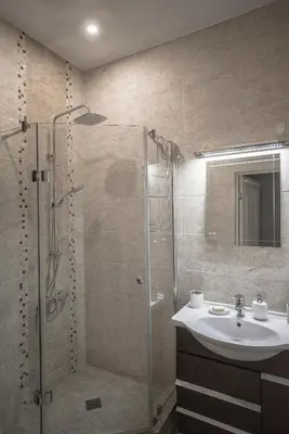 a bathroom with a shower and a sink at Valeri Aprtment in Kaunas