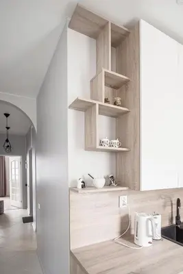 a kitchen with wooden shelves on the wall at Valeri Aprtment in Kaunas