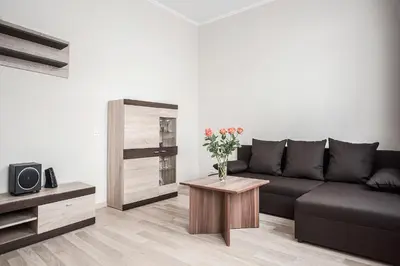 a living room with a couch and a table with flowers at Valeri Aprtment in Kaunas