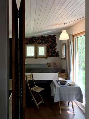 a room with a table and chairs and a bedroom at Inkilas in Sidabrinės