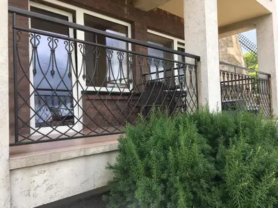a balcony with a wrought iron fence on a house at Šeduvos malūnas in Šiauliai