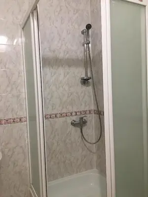 a shower with a shower head and a bath tub at Šeduvos malūnas in Šiauliai