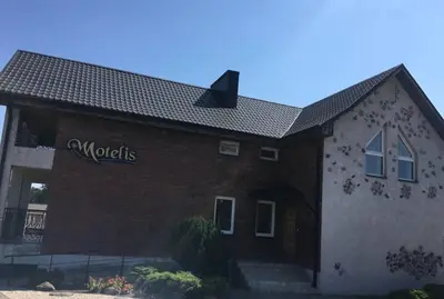 a building with a sign on the side of it at Šeduvos malūnas in Šiauliai