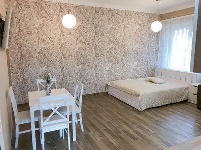 a bedroom with a bed and a table and chairs at Marsas in Zarasai
