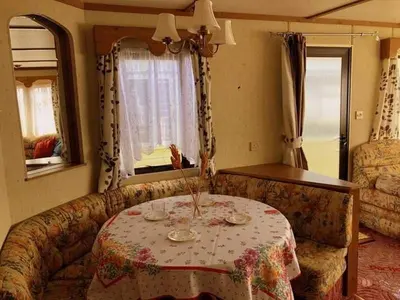 a living room with a table and a couch at NeriPaulis in Ažvinčiai