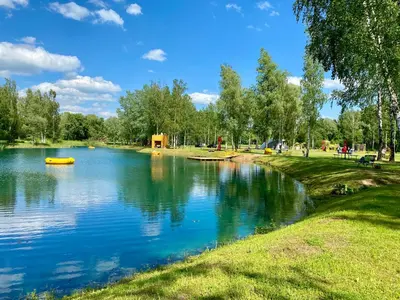 a river with a yellow boat in a park at Marijampole Camping in Marijampolė