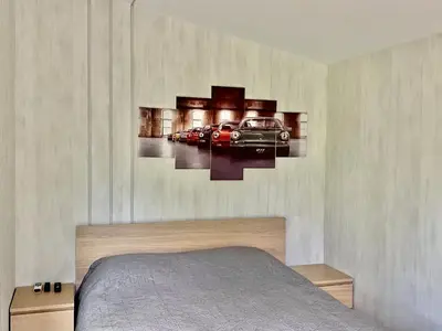 a bedroom with a bed with cars on the wall at Marijampole Camping in Marijampolė