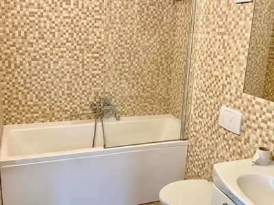 a bathroom with a tub and a toilet and a sink at Marijampole Camping in Marijampolė