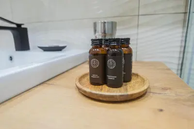 three bottles of sauce sitting on a table at Central and Relaxing apartment in Druskininkai