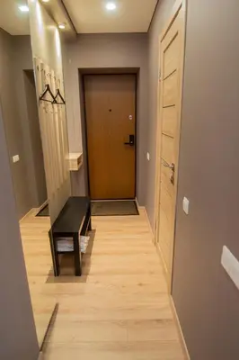 a hallway with a door and a wooden floor at Central and Relaxing apartment in Druskininkai