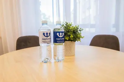 two bottles of water sitting on top of a table at Central and Relaxing apartment in Druskininkai