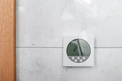 a switch on a wall with a clock on it at Small attic rooms in Kaunas old town in Kaunas