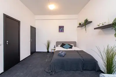 a bedroom with a bed in a white room at The house Vilnius in Vilnius