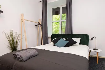 a bedroom with a bed with pillows and a window at The house Vilnius in Vilnius