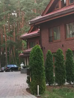 a house with a man standing in front of it at Centro apartamentai in Birštonas