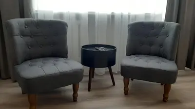 two chairs and a table in a room at Jaukūs apartamentai-studija, centre in Šiauliai