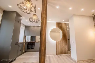 a kitchen with a large pole in the middle of a room at Jaukūs apartamentai-studija, centre in Šiauliai