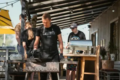 a group of people in a kitchen preparing food at Natur Camp Birštonas in Birštonas