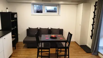 a living room with a table and a couch at Muziejaus 10 studija in Anykščiai