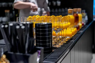 a row of wine glasses sitting on a bar at Mana Sleep & Spa in Druskininkai